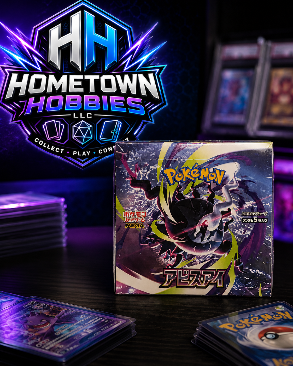 A sealed Pokémon TCG booster pack box stands on a dark tabletop, surrounded by stacks of trading cards and a large Hometown Hobbies LLC logo in the background.