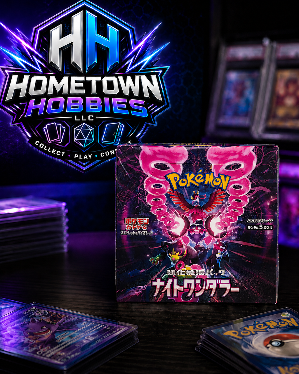 A boxed Pokémon TCG product stands on a dark tabletop with several card packs and cards around it. The main subject is the front of the Pokémon box featuring bright pink monster artwork and Japanese text.