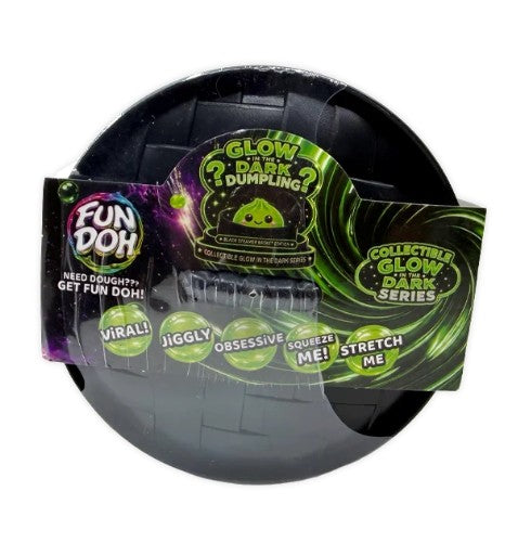 Fun Doh Glow Dark Dumpling collectible toy in its original retail packaging, featuring a black spherical dumpling with a glowing green center and a colorful cardboard sleeve.