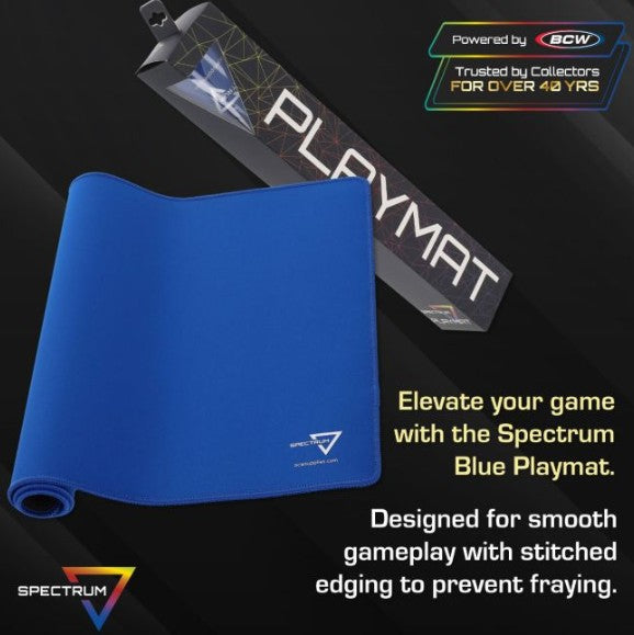 A rolled blue gaming playmat is shown in front of its black branded box on a dark background, with promotional text reading 'Powered by SCW' and 'Elevate your game with the Spectrum Blue Playmat.' The playmat has a small white Spectrum logo near the lower right corner.