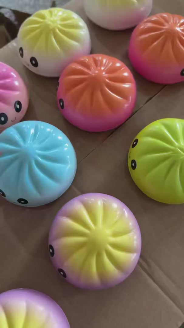 A video showcasing the slow rise squishy dumplings with the different color options.