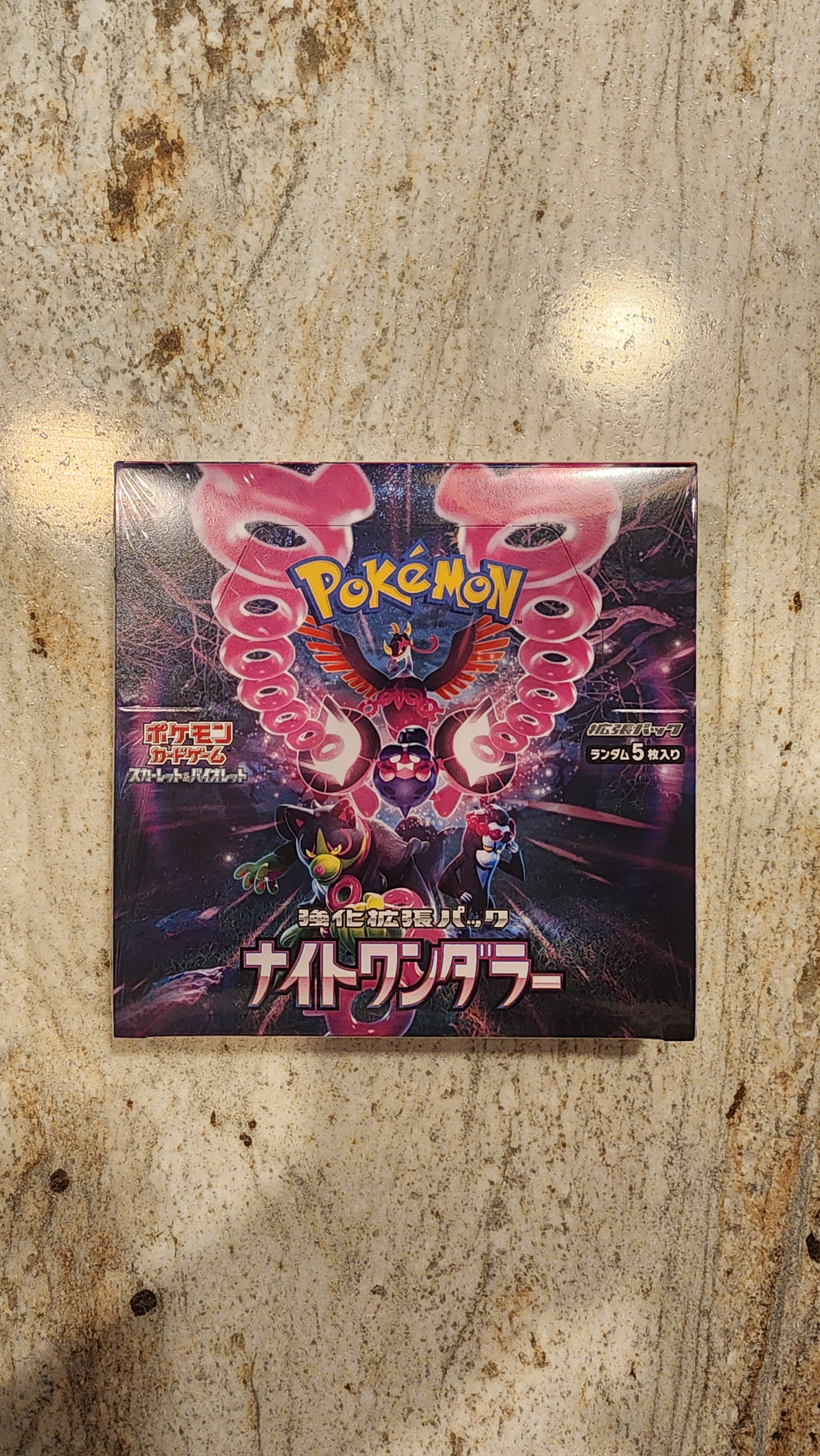 Pokémon Booster Deck box for the Dawn of the Dragon TCG, featuring a vibrant pink and purple dragon illustration on a marble surface.